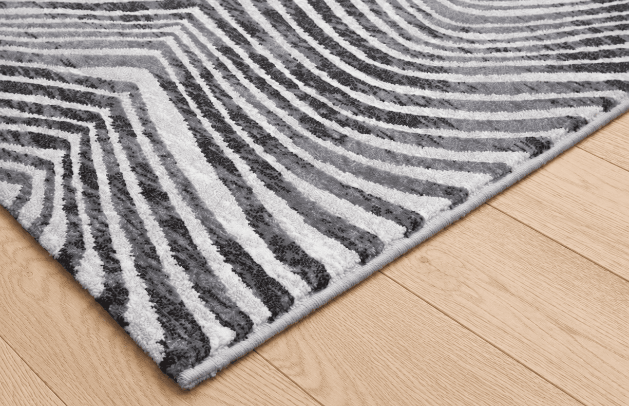 Tepih Gent ZEBRA moderni crno bijeli tepih s valovitim zebra prugama, sivim detaljima i teksturiranom površinom od 100% PP Heatset materijala.